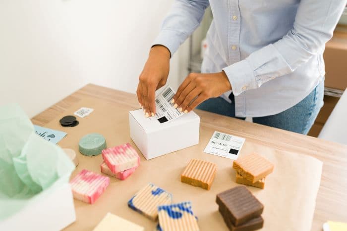 woman putting a shipping label to a package