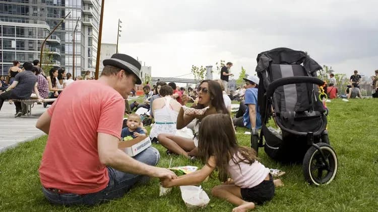 Man with children all sitting in the park