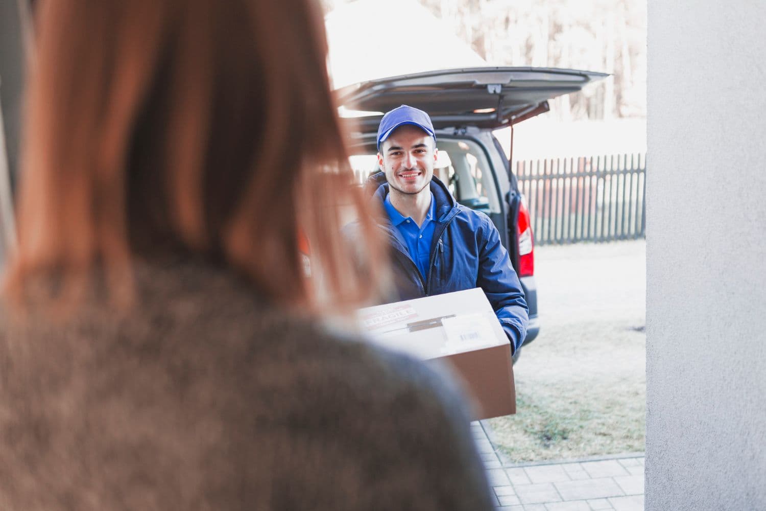 Woman greeting deliveryman