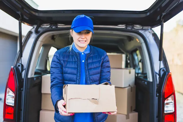 women carrying ripped box